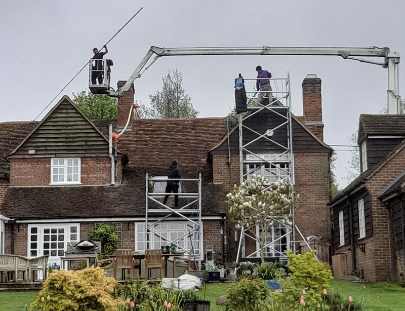 The Roof Moss Cleaners using cherry picker and scaffolding to clean roof safely and professionally in Stondon, Bedfordshire