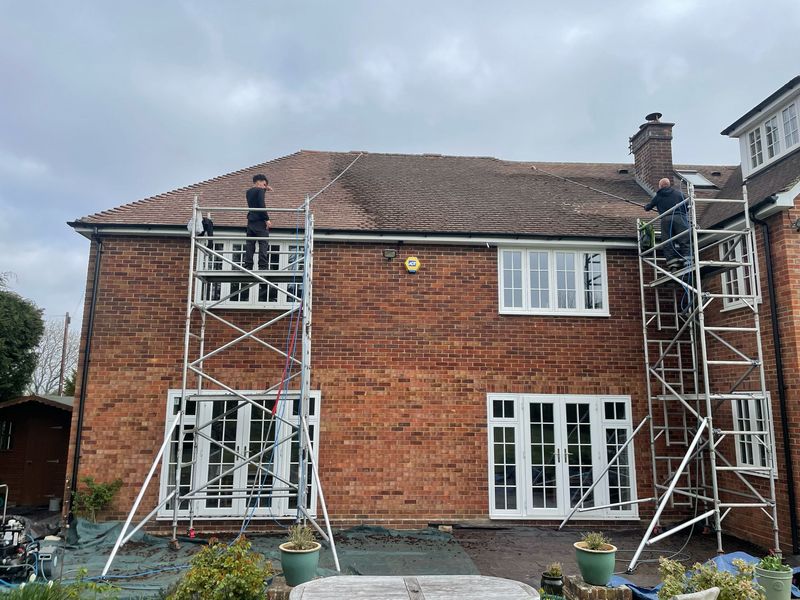 Roof cleaning carried out safely from scaffold towers by The Roof Moss Cleaners in Stondon